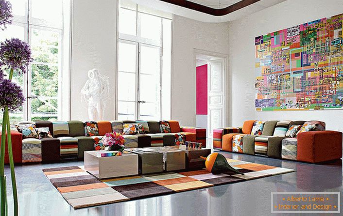 Šarena gostinjska soba u avantgardnom stilu u velikoj kući italijanske porodice. Ideja dizajna kompetentno kombinuje pokrivač tepiha i nameštaj od otprilike identične boje.