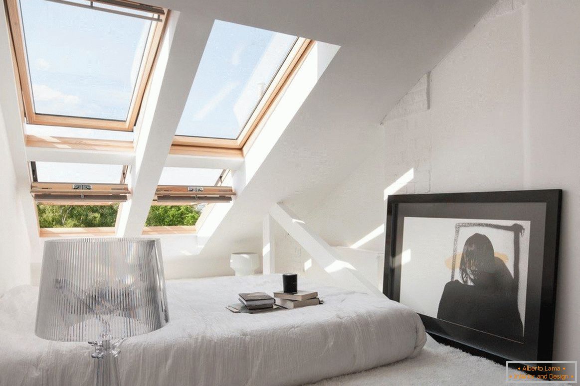 Udobna spavaća soba sa prozorima na krovnoj padini